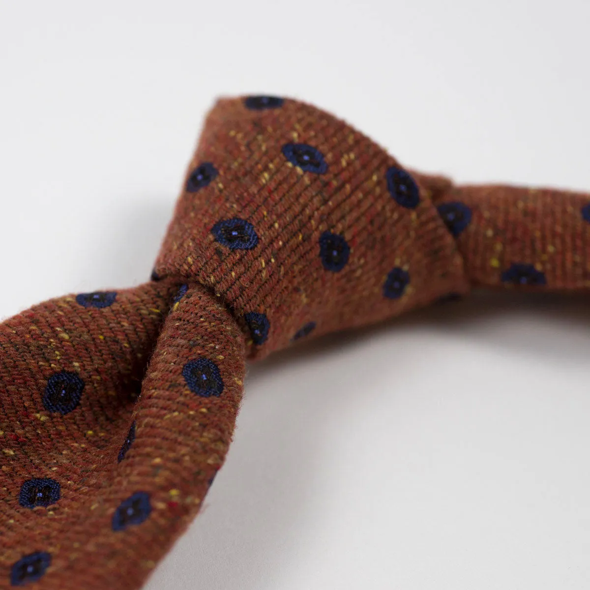 Rust silk and wool donegal tie, navy neat motifs