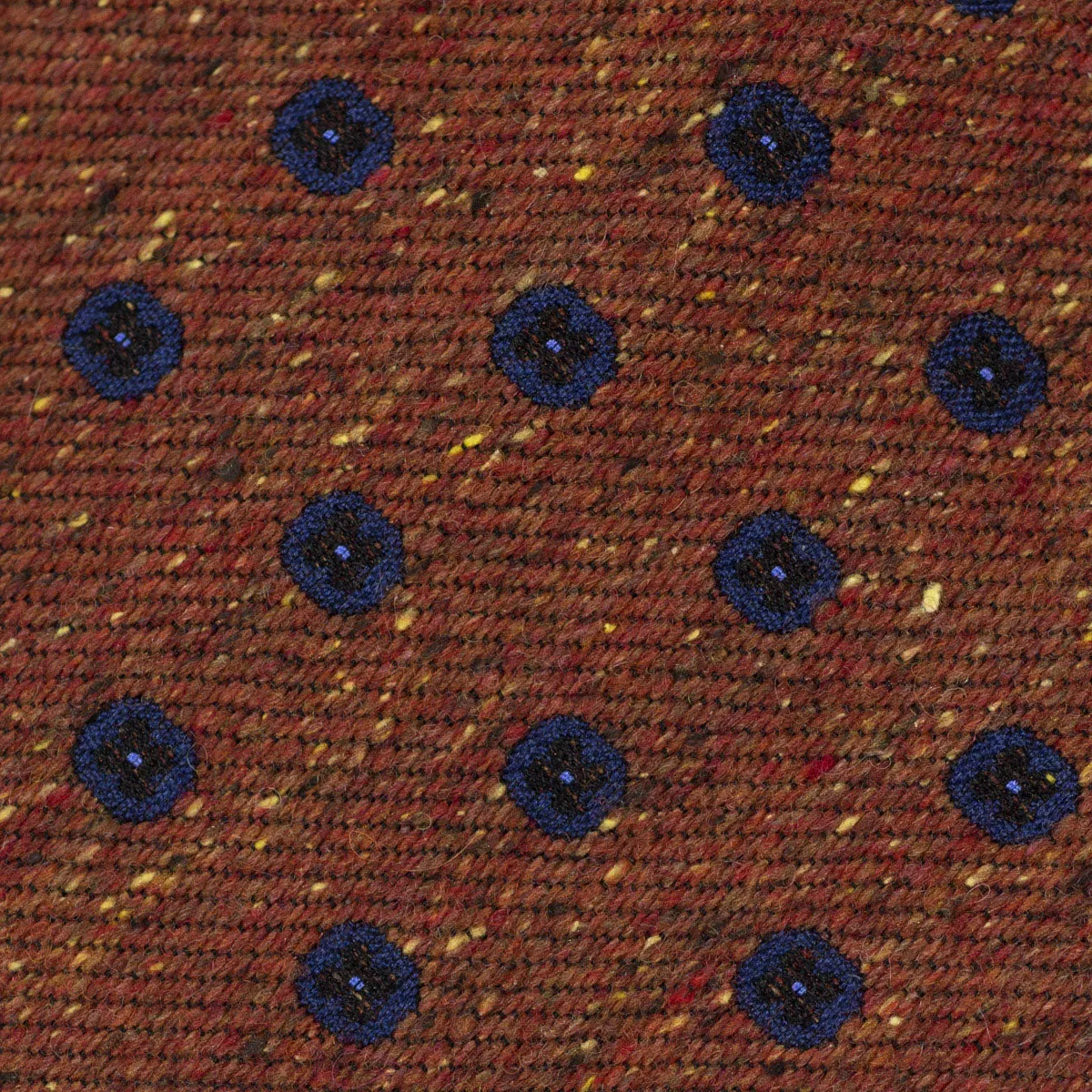 Rust silk and wool donegal tie, navy neat motifs